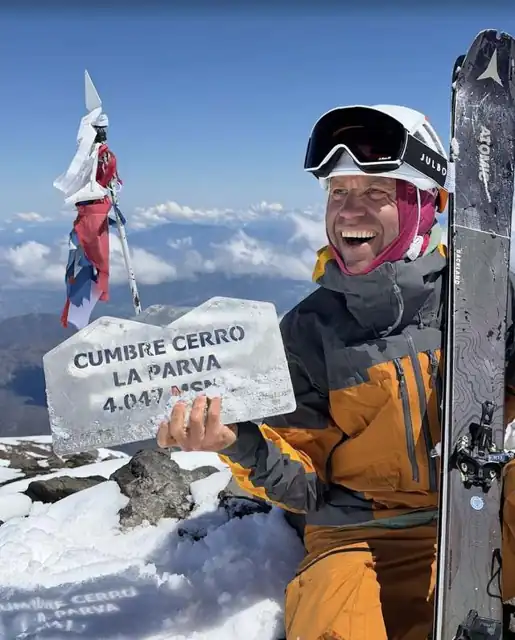 Jon Brizuela holding the Cerro La Parva summit sign, 4,047 meters, above Santiago