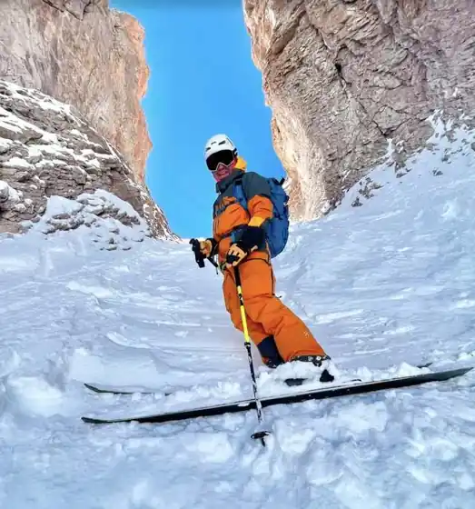 Jon Brizuela skiing a narrow rock couloir in the Andes